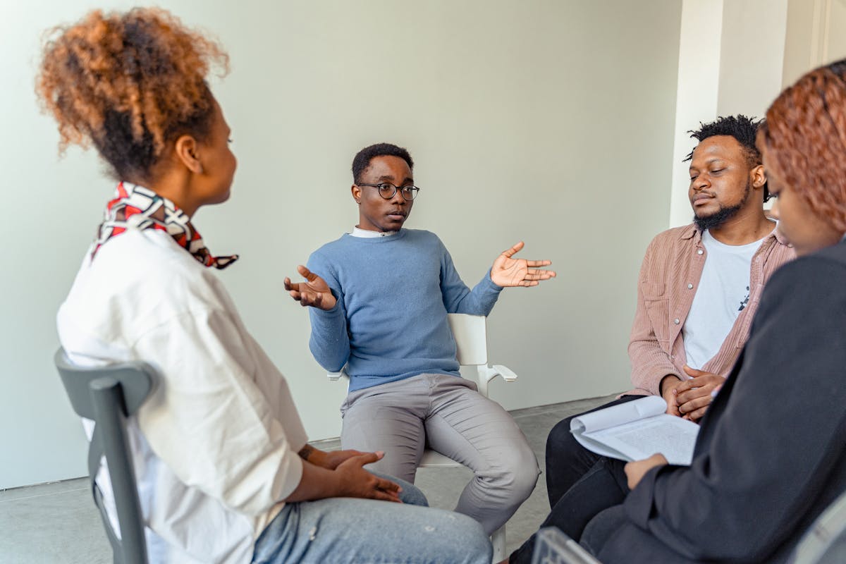 Group therapy session: the family sitting in a circle in a bright room