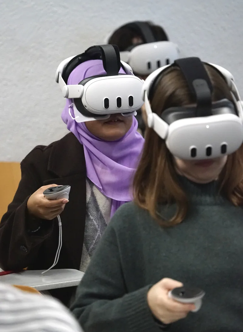 Two students exploring the VR scenarios side by side